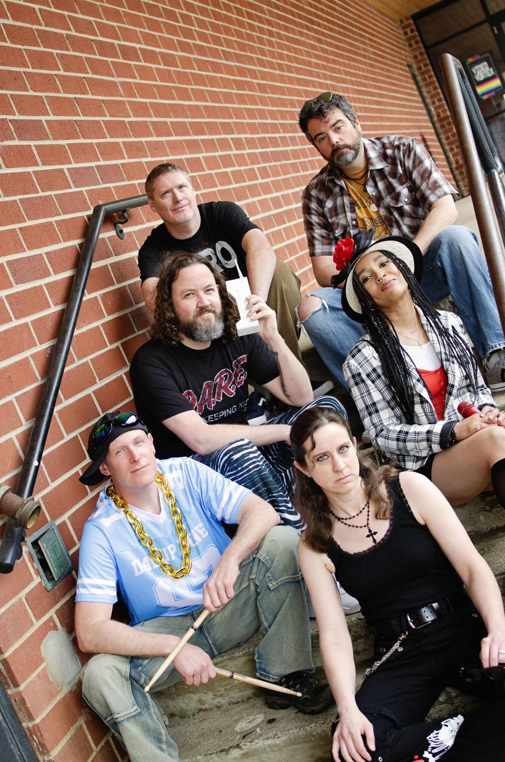 Band members sitting on stairs