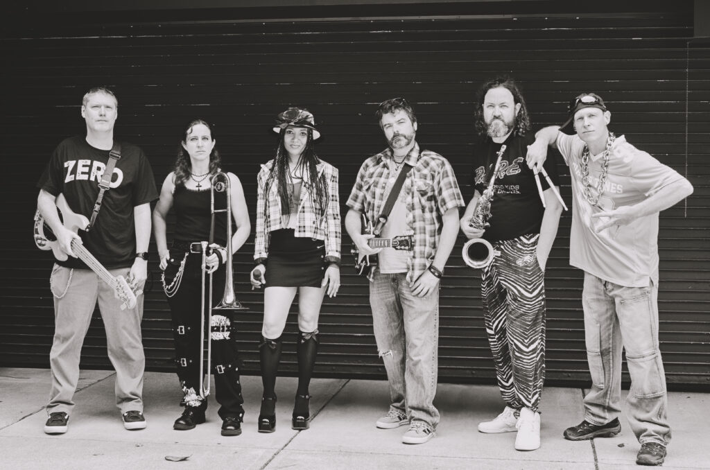 Black and White photo of the band members in front of a dark background